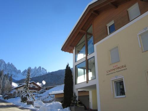 a building with a mountain in the background at Haus Tannenburg in Funes