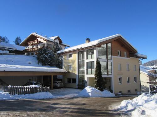 a building with snow in front of it at Haus Tannenburg in Funes