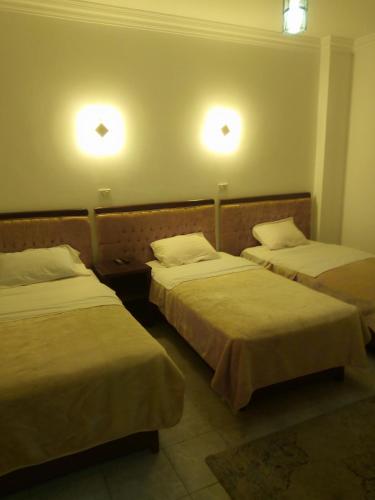 two beds in a room with two lights on the wall at Arabian Nights Hostel in Cairo