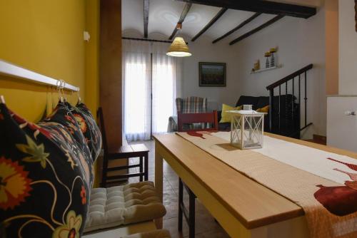 a living room with a table and a dining room at LA CASICA in Segorbe