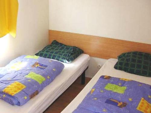 Ένα ή περισσότερα κρεβάτια σε δωμάτιο στο Camping le P'Tit Bonheur