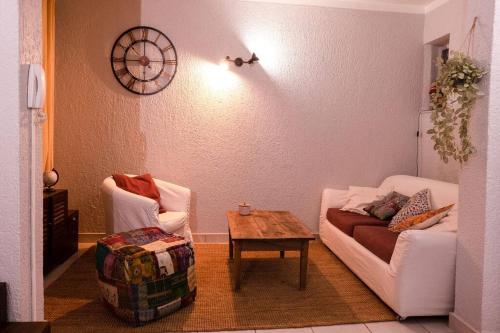 a living room with a couch and a table at Gites de la Lurette - agréable T2 indépendant dans cadre calme et verdoyant in Cazilhac