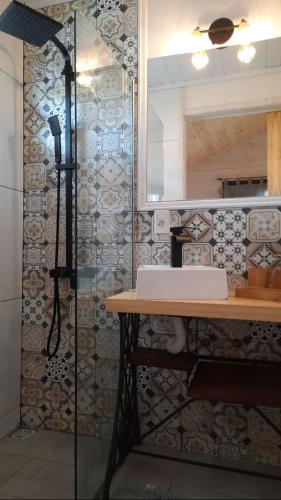 a bathroom with a sink and a mirror and a table at Ocean Paradise 1 in Punta Del Diablo
