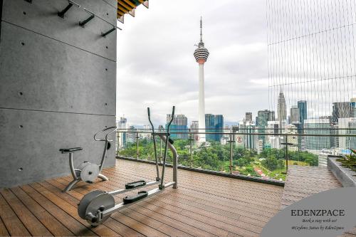 a gym with a view of a city skyline at Ceylonz Suites by EdenZpace in Kuala Lumpur