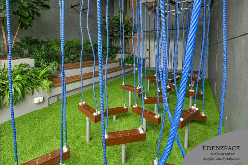 a row of swings with blue ropes at Ceylonz Suites by EdenZpace in Kuala Lumpur