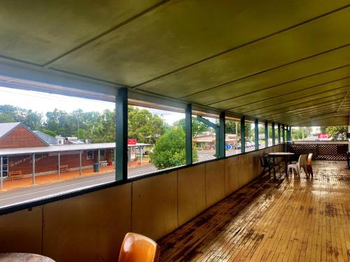 a room with windows and a table and chairs at Royal Carrangarra Hotel in Tambo