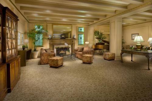 a living room with a fireplace and a table and chairs at Mayflower Park Hotel in Seattle