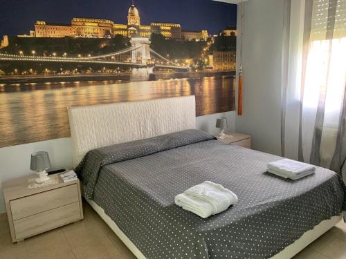 a bedroom with a bed with a view of the city at Acquamarina Apartment in Marzamemi
