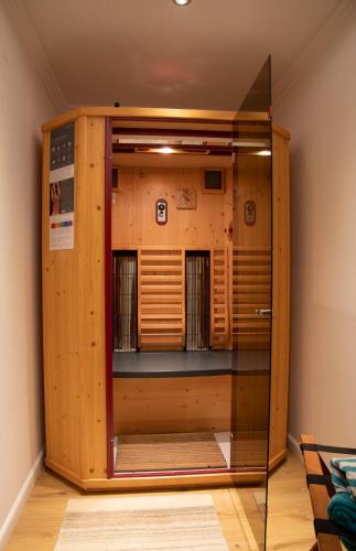 a wooden cabinet with a glass door in a room at Haus Hamatli in Sankt Anton am Arlberg