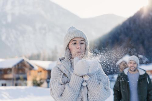 a woman playing with snow in the snow at Feelfree Nature Resort in Oetz