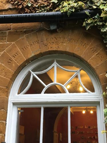 a window of a building with writing above it at The Old Vicarage in Flore