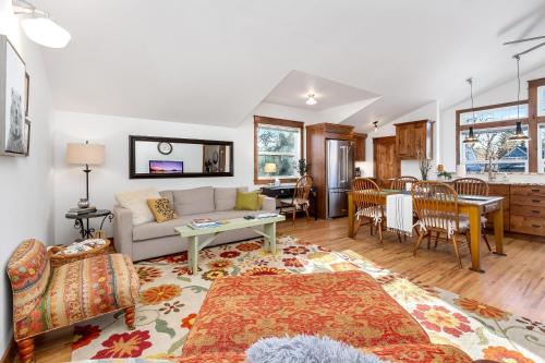 a living room with a couch and a table at The Beautiful Bears Den! Walk to Old Town and CSU! in Fort Collins