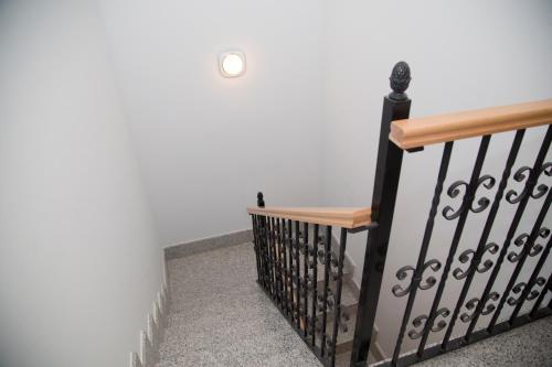 a stair railing with a wooden bench on it at Apartamentos La Plazuela Baños de Montemayor in Baños de Montemayor