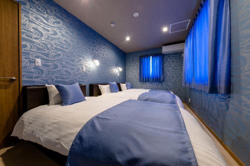 Кровать или кровати в номере 01 Resort Club -結YUI-