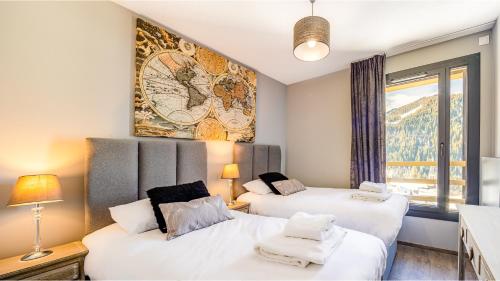 two beds in a room with a mural on the wall at The View - Apt 09 - BO Immobilier in Châtel