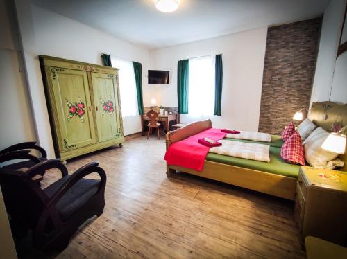 a bedroom with a bed with a red blanket on it at Hotel Landgasthof Sonne in Mahlberg