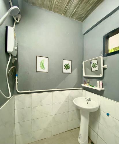 a bathroom with a sink and a shower at YOYO HOUSE in Chiang Rai