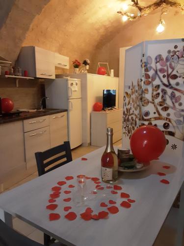 a kitchen with a table with a bottle of wine at C'era Una Volta... in Altamura
