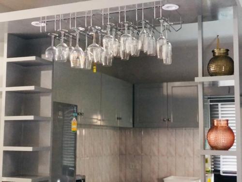 a kitchen with several glass jars hanging from the ceiling at My PoolVilla Cha am in Cha Am