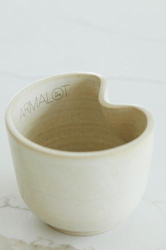 a white bowl sitting on top of a table at B&B Armalot by Julia in De Panne