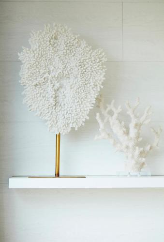 a white flower vase on a white shelf at B&B Armalot by Julia in De Panne
