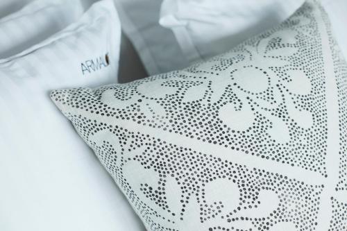 a close up of a white shirt with a patterned tie at B&B Armalot by Julia in De Panne
