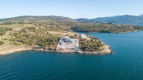 an aerial view of a house on an island in the water at Iris Villas in Spárton