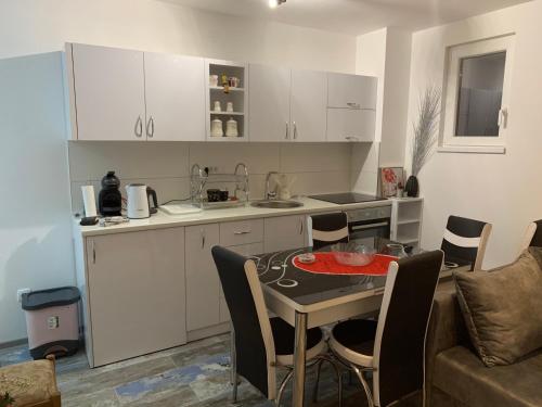a kitchen and a table in a living room at Apartmani Miletić A7 in Divčibare
