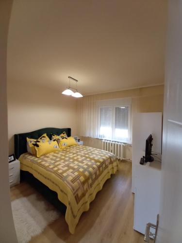 a bedroom with a large bed with yellow pillows at TEI in Oradea