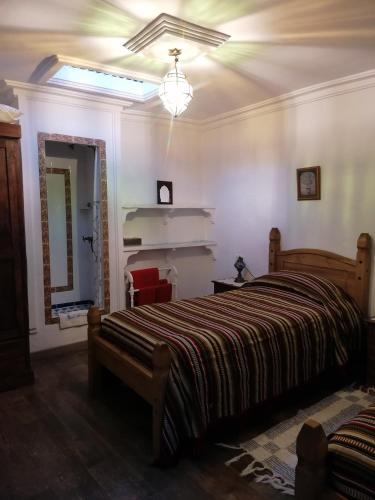 a bedroom with a bed and a light on the ceiling at Casa Natalia in Mecina Fondales