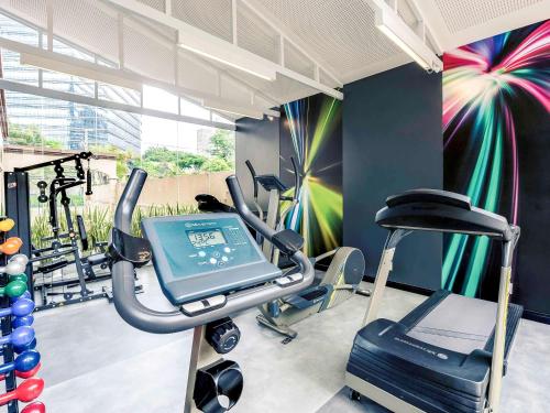 a fitness room with a treadmill and a gym at Mercure Sao Paulo JK in Sao Paulo