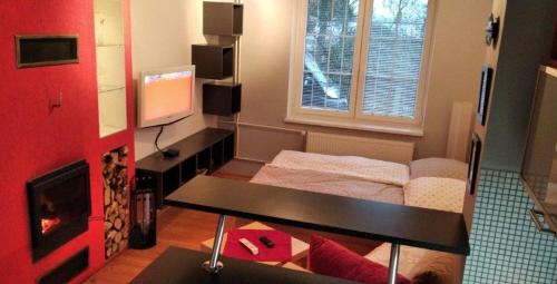 a living room with a couch and a table and a television at Apartmán v Liliové in Jablonec nad Nisou
