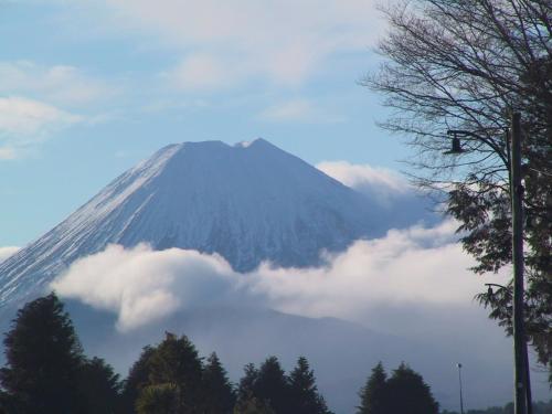 a snow covered mountain with clouds in front of it at Howard's Mountain Lodge in National Park