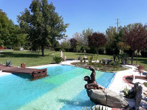 a statue of a bear in a swimming pool at Dogana Vecchia - Hotel & Residence B&B Ristorante & Pizzeria in Trivignano Udinese