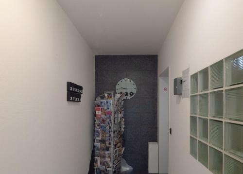 a room with a wall with a clock on the wall at Relax Aachener Boardinghouse Budget in Aachen