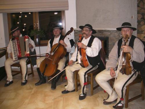 a group of men playing instruments in a room at Willa Grywałd in Grywałd