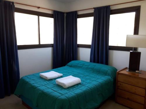 En eller flere senge i et værelse på Casa en La Cumbrecita