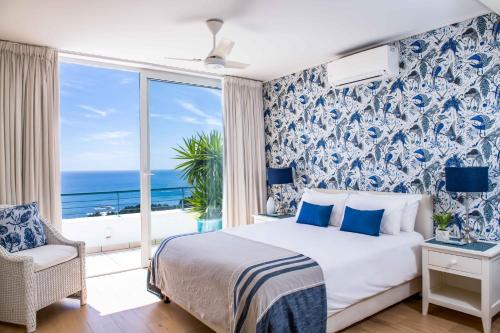 a bedroom with a bed with a view of the ocean at Bay Reflections Camps Bay Luxury Serviced Apartments in Cape Town