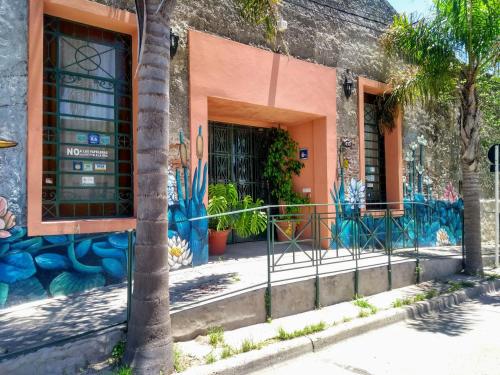 a building with graffiti on the side of it at Posada Ribera del Gualeguaychu in Gualeguaychú