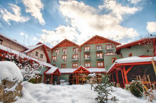 a large building with snow in front of it at Hotel Kotarz Spa&Wellness in Brenna