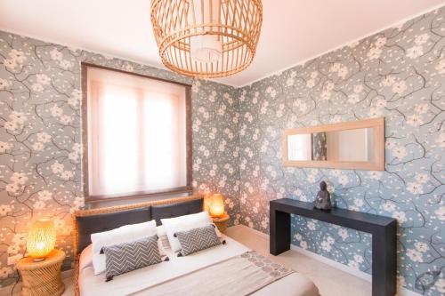 a bedroom with a bed and a mirror on the wall at Le Camere Pietrasantine - Centro Storico in Pietrasanta