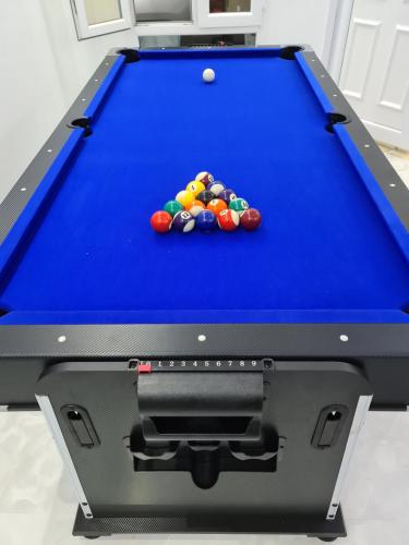 a blue pool table with balls on it at فلة ايكيا in Sohar