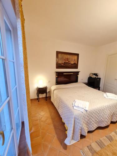 a bedroom with a bed and a painting on the wall at B&B Luna Nuova in Sarzana