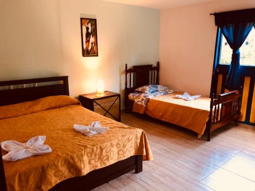 Postel nebo postele na pokoji v ubytování Posada La Loca Compañía