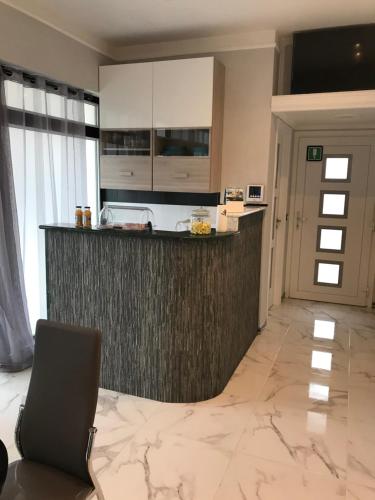 a kitchen with a counter and a chair in a room at Guest House Bracciano RM in Bracciano