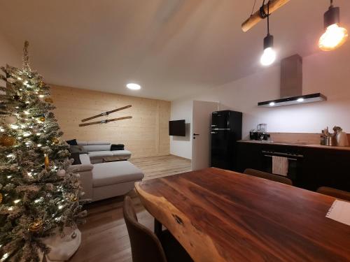 a living room with a christmas tree and a table at Haus Fien in Heiligenblut