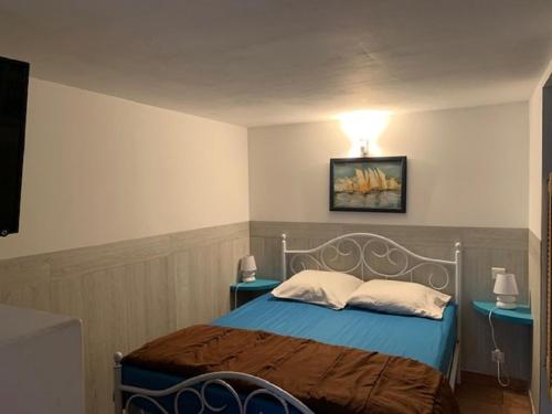 a bedroom with a bed with a light on the wall at Gîte de Saint Cassien in Montauroux