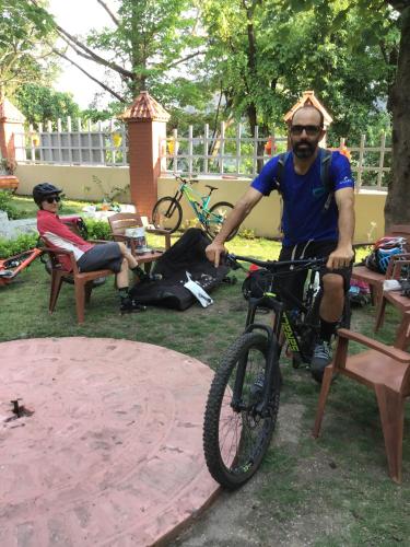a man is riding a bike in a park at DreamCatcher By Samyati Hotels and Resorts in Bhīm Tāl