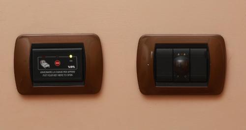 two brown switches are attached to a wall at Caprice in Avigliana
