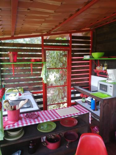 a kitchen with a table and a stove in a house at The House of Hummingbird in Atenas